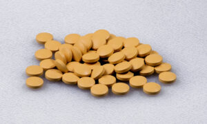 Generic cyclobenzaprine pills on a white surface.