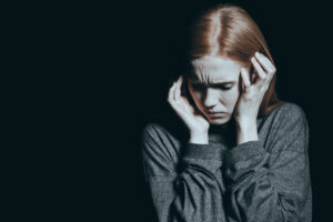 Fearful woman covering her ears